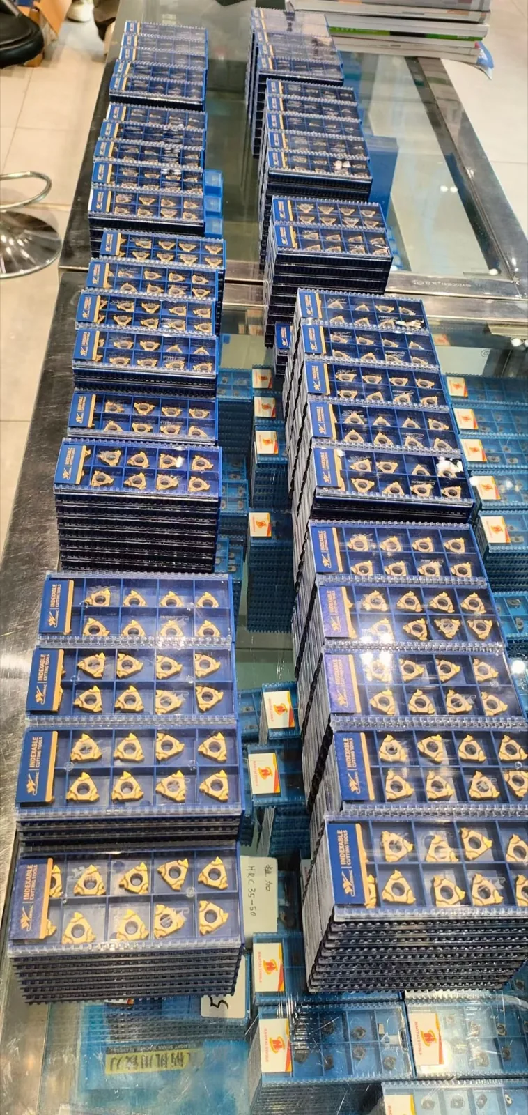 Indexable cutting inserts arranged in blue stock boxes