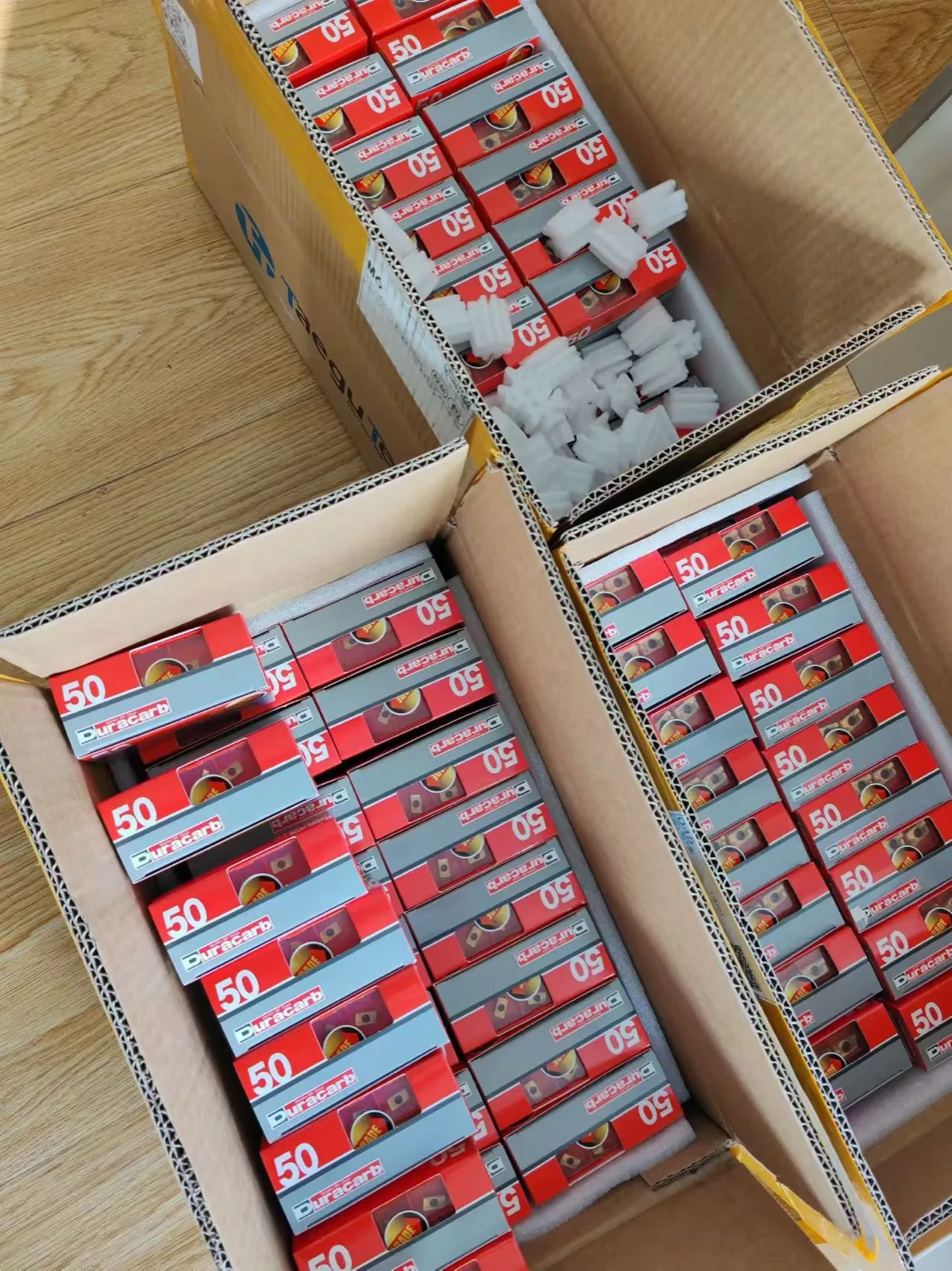 Boxed cutting inserts being prepared for an order